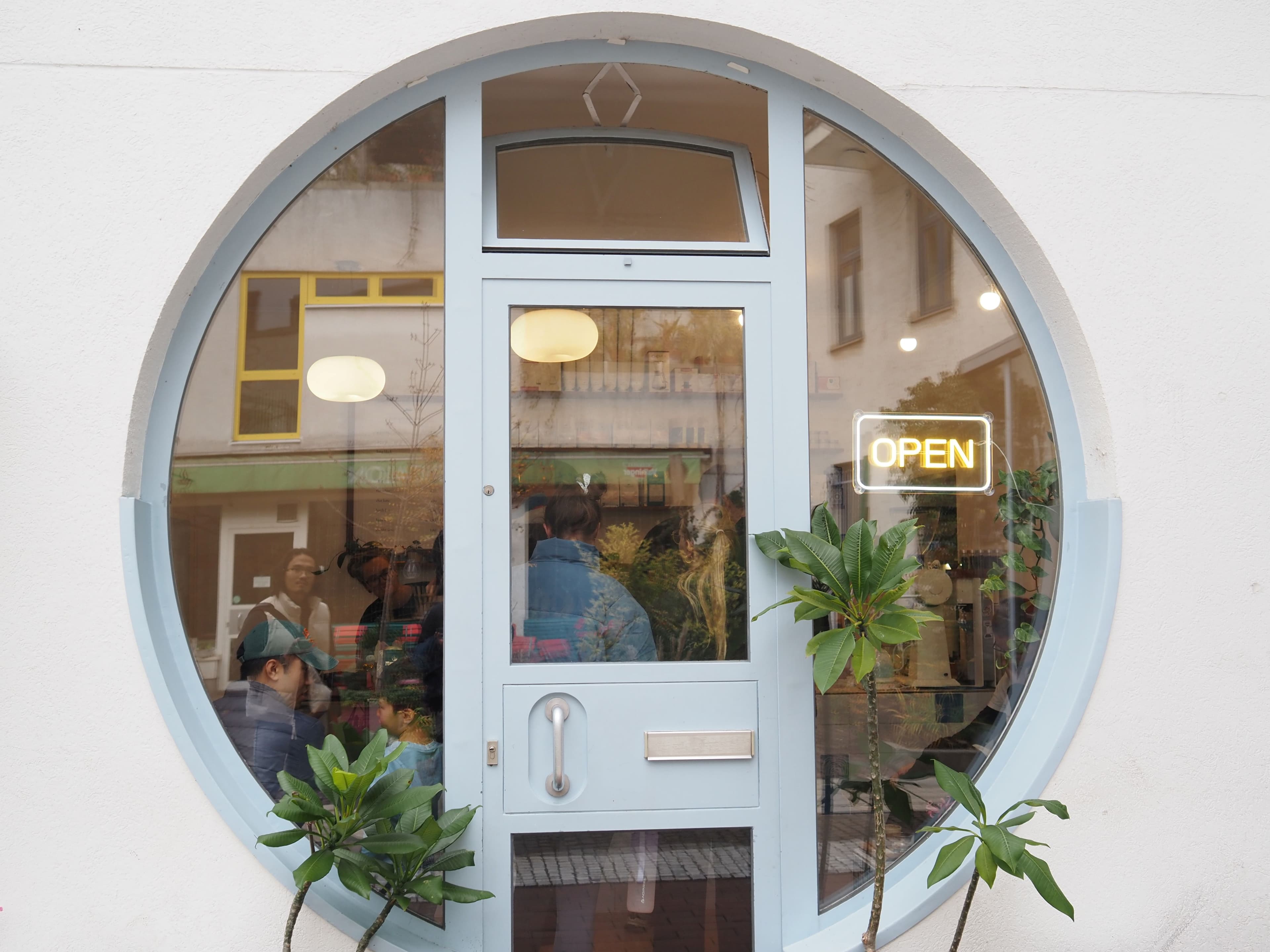 Inside the Humpback Whale café in Munich, seen through a porthole window